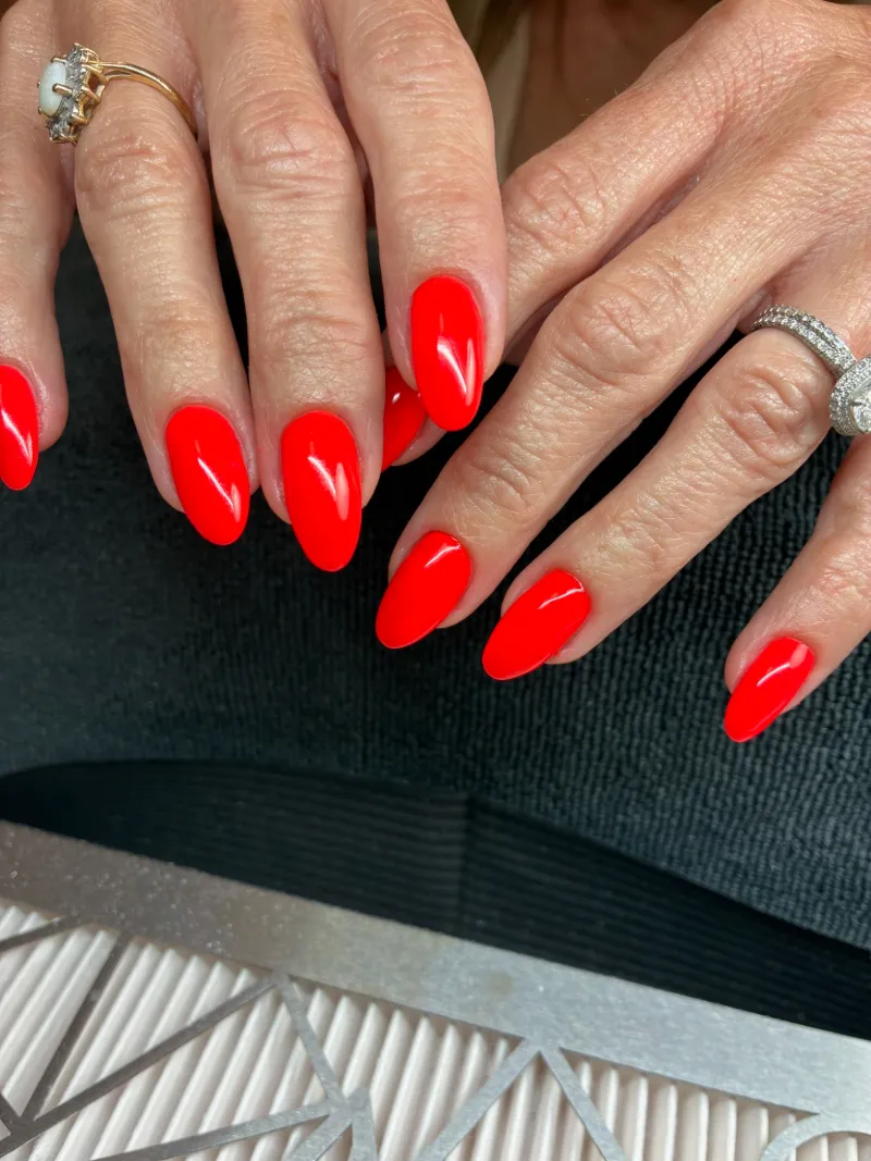 Glossy bright red almond nails